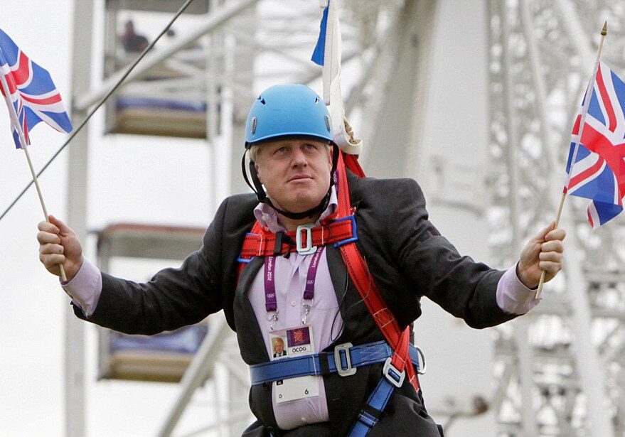 LONDON, UNITED KINGDOM - AUGUST 01: Mayor of London Boris Johnson after he gets stuck on a zip-line during BT London Live in Victoria Park on August 01, 2012 in London, England.  London Mayor Boris Johnson has proved he is ready to put his body on the line for a successful 2012 Olympics - but he might have gone too far in his latest stunt after getting stuck on a zip-line in Victoria Park. Mr Johnson was a guest at a BT London Live event at the east London park, where visitors can watch the Games action on a big screen or try their hand at a range of Olympic sports. But the mayor quickly became a major talking point on Twitter after pictures taken by people at the park surfaced of him dangling awkwardly from the wire, while brandishing a couple of Union flags. Several pictures showed Mr Johnson hanging from a harness wearing a blue helmet while waving the flags, although it is uncertain whether he was intending to stop where he did - or if it was a true zip-line malfunction. Earlier this week a poll of Conservative voters suggested the mayor was their top choice to succeed David Cameron as prime minister. He has so far enjoyed a high-profile Games, kicked off by addressing 60,000 people in Hyde Park on the day of the opening ceremony by taunting Republican presidential nominee Mitt Romney over his comments apparently doubting London's readiness to host.  PHOTOGRAPH BY Barcroft Media  UK Office, London. T +44 845 370 2233 W www.barcroftmedia.com  USA Office, New York City. T +1 212 796 2458 W www.barcroftusa.com  Indian Office, Delhi. T +91 11 4053 2429 W www.barcroftindia.com